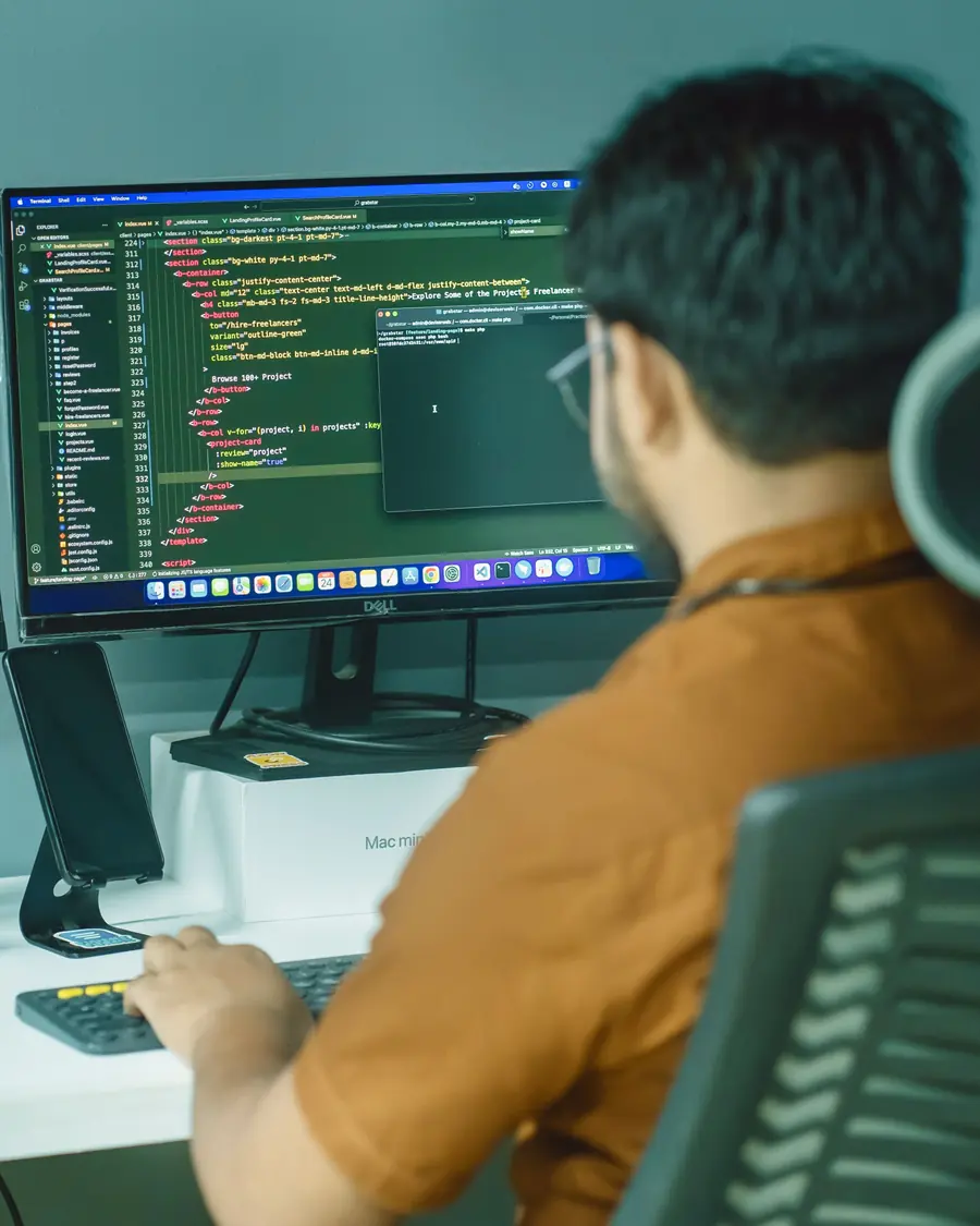 Developer focused on code across two monitors