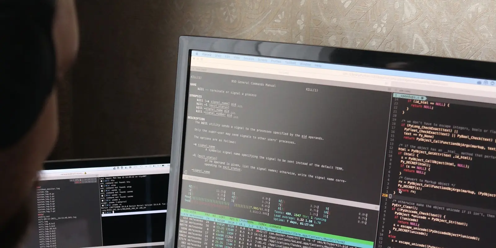 Engineer working with a terminal and code on a monitor