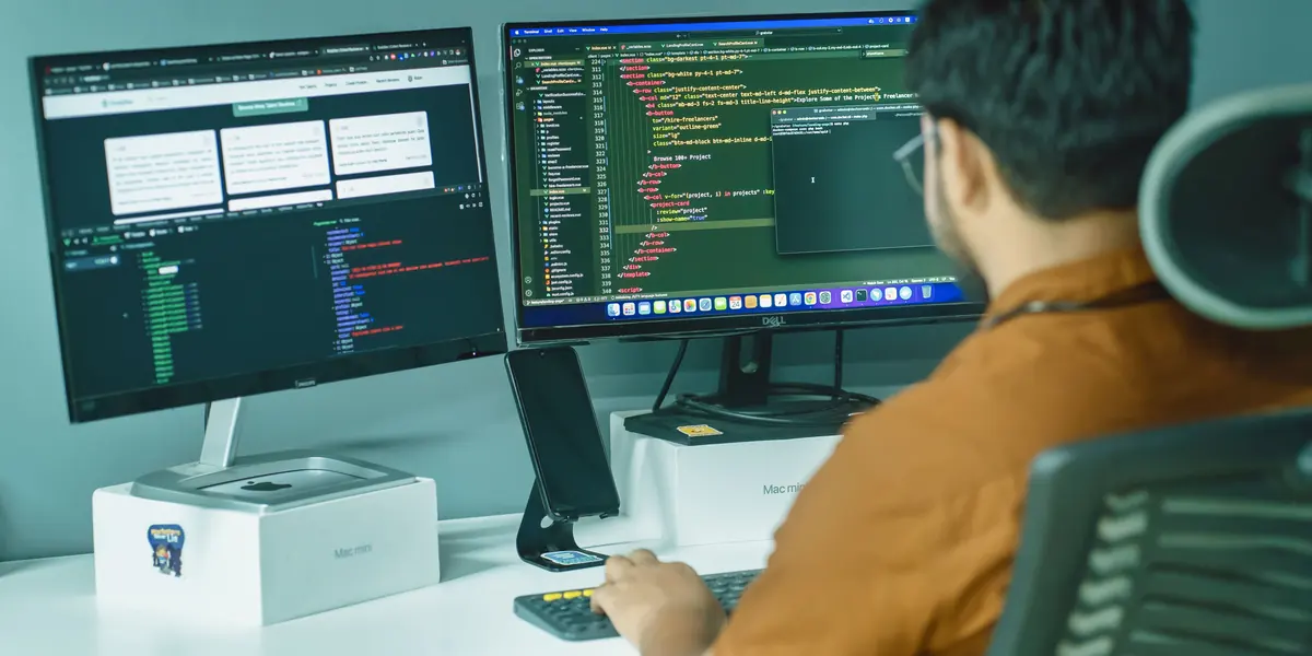 Developer working at a dual-monitor desk